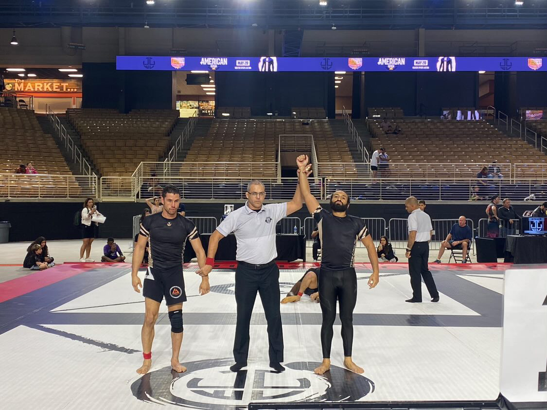 Rudos BJJ competitor Stephen Diaz getting his hand raised after winning No-Gi tournament gold.