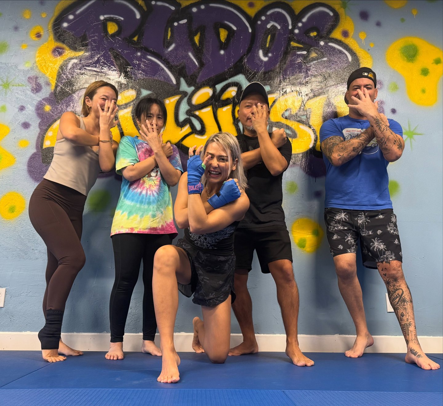 Wednesday Kickboxing and BJJ class in front of the yellow and purple Rudos Jiu-Jitsu mural with Giulia, Sumie Sakai, and Professor David Floridia